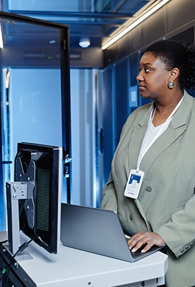 Woman standing next to a computer in a server