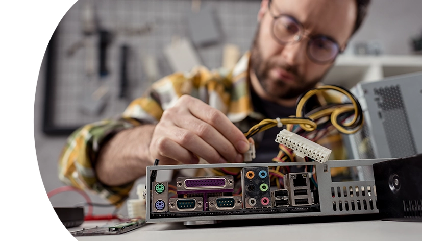 man adjusting wires on broken pc