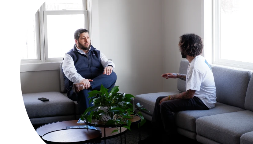 Michael sitting on sofa in SecureWon office talking to colleague