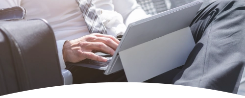 businessman using laptop to attend webinar while on the move